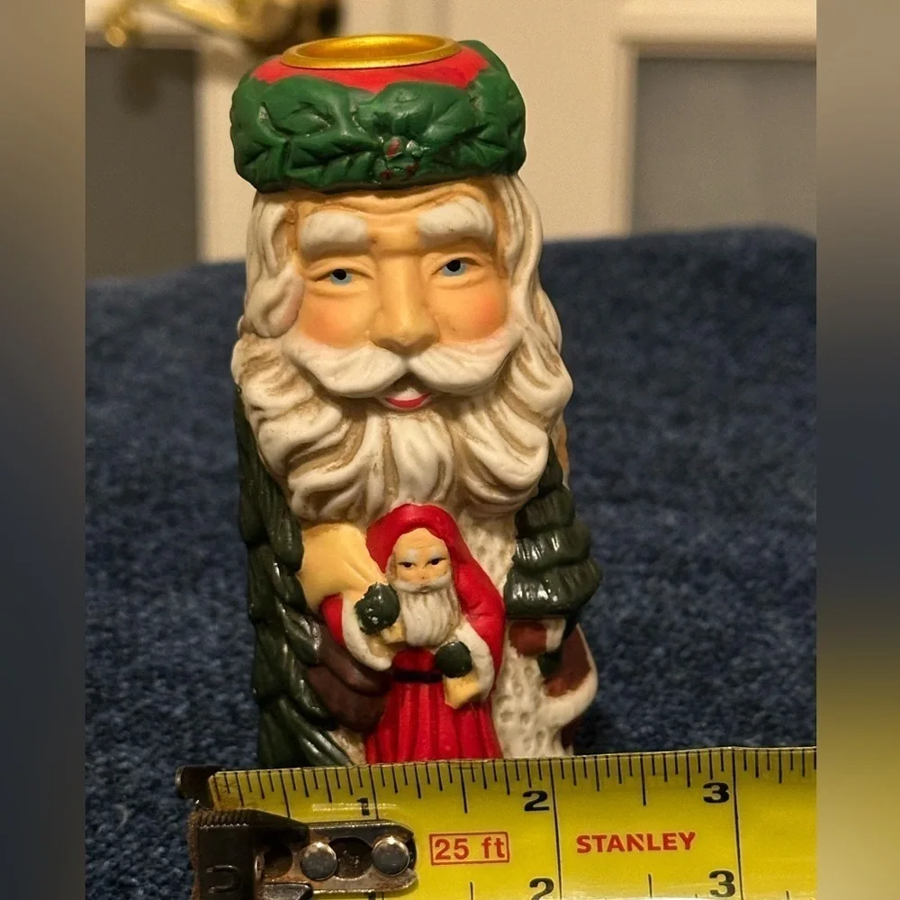 Set of 2 Santa candleholders. Each has smaller different smaller Santas.